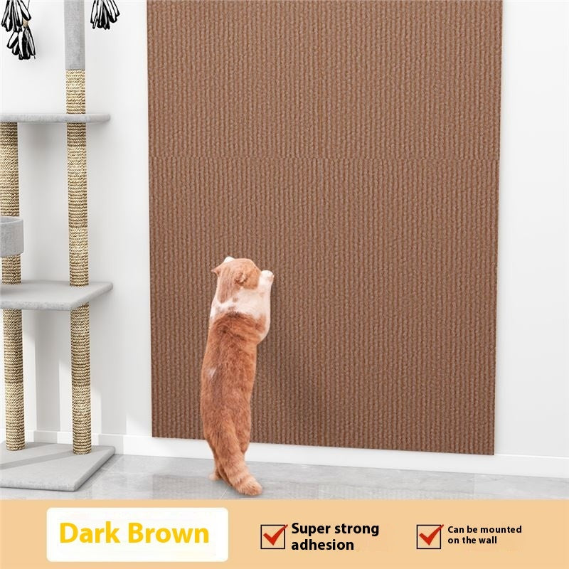 Cat standing on a dark brown wall mat with a cat tree in the background
