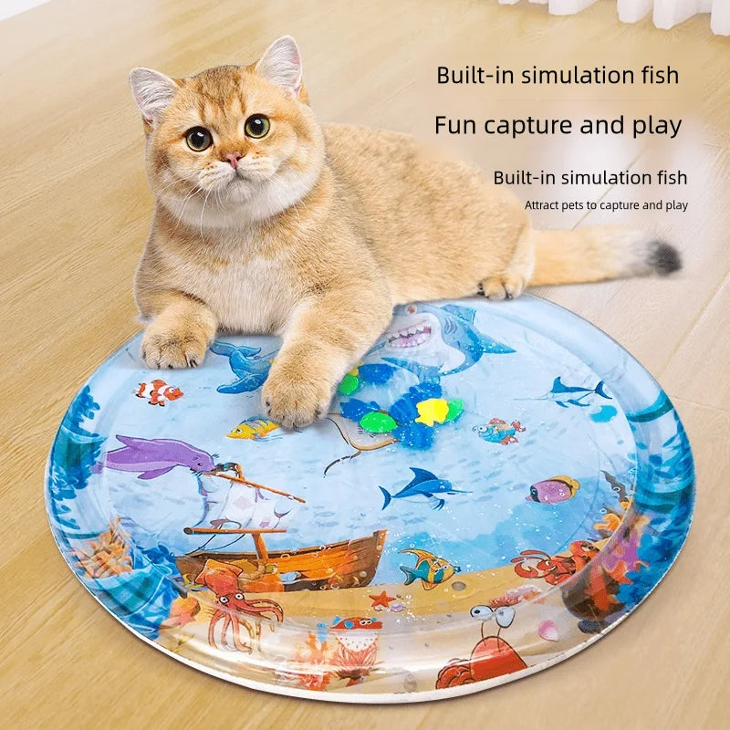 Cat playing with a round mat featuring ocean-themed illustrations on a wooden floor.