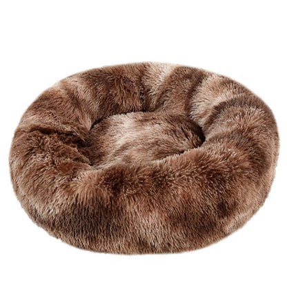 Brown faux fur donut pet bed on a white background