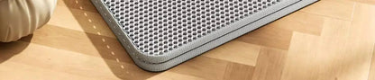 Gray textured mat on a wooden floor