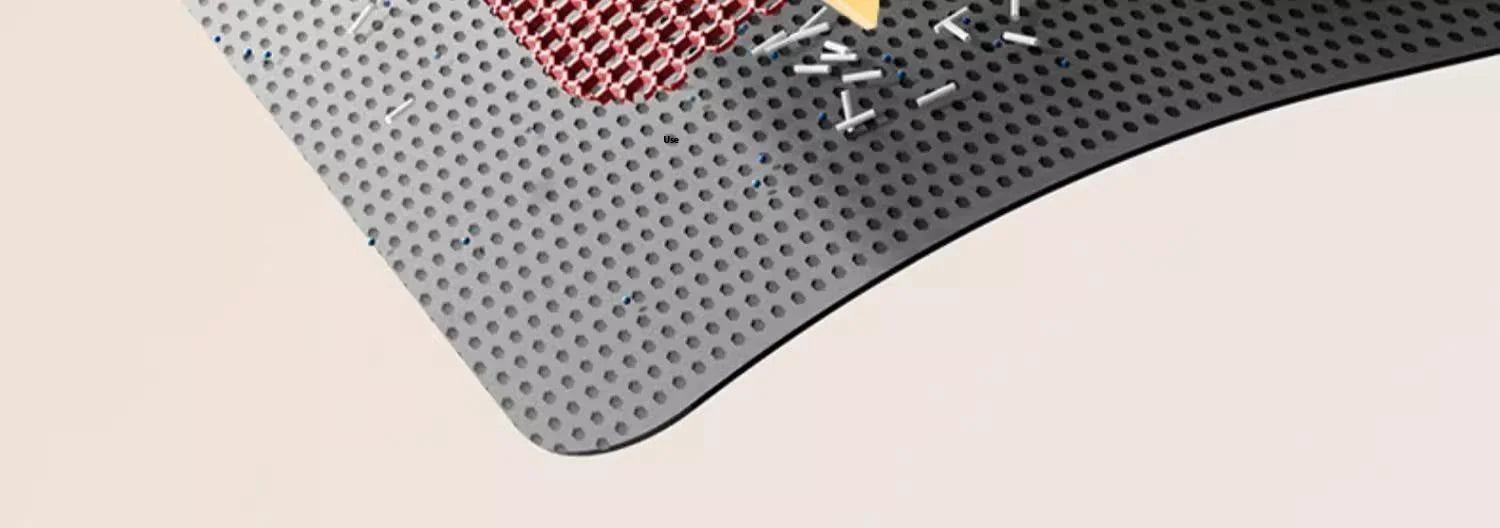 Gray textured mat with a small red object on a beige surface