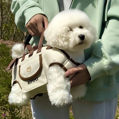 White dog in a small bag held by a person outdoors