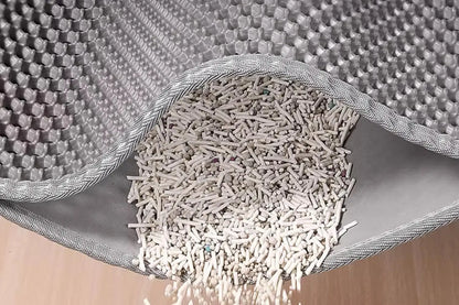 Cat litter in a scoop with a textured gray container