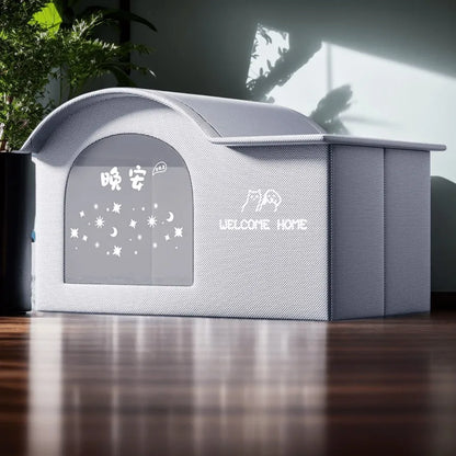 Gray pet house with decorative window and 'Welcome Home' text on a wooden floor.