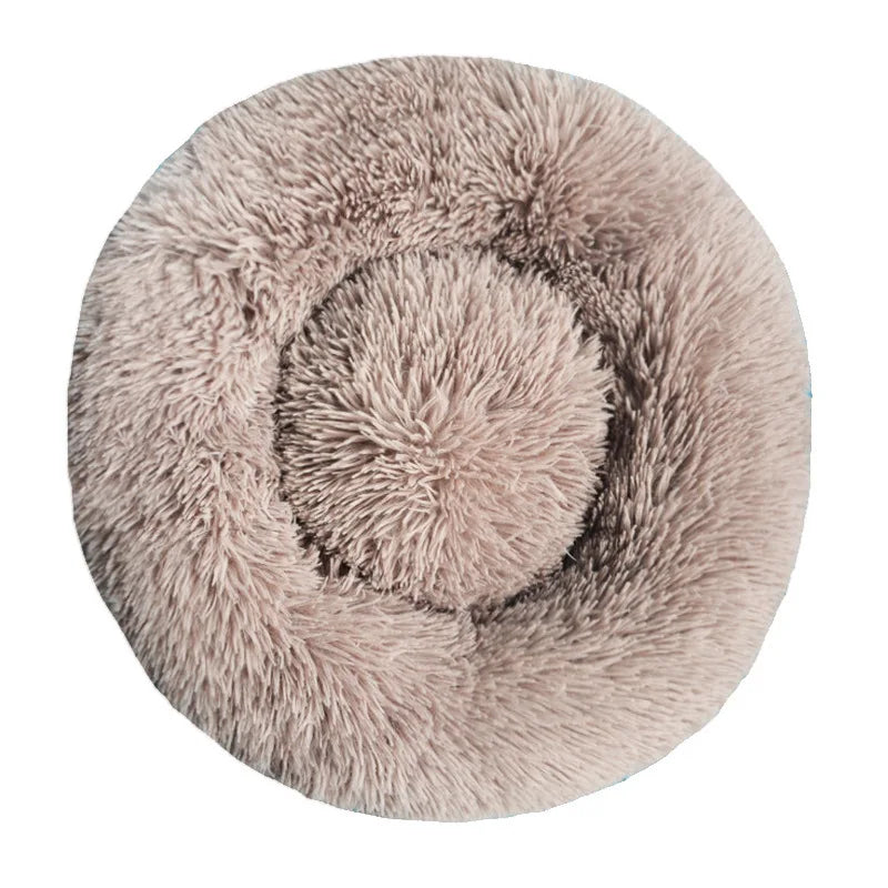 Round fluffy pet bed on a white background