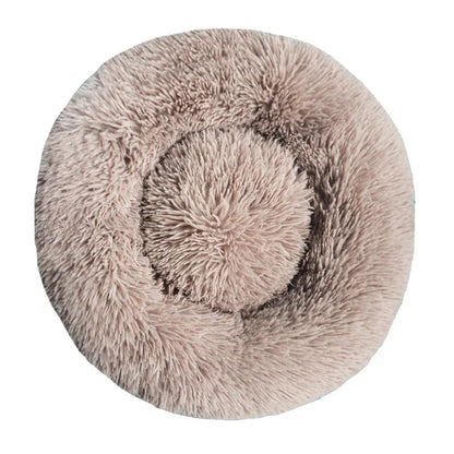 Round fluffy pet bed on a white background