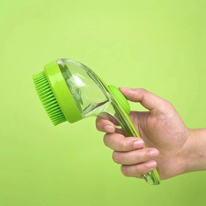 Hand holding a green and clear cleaning brush against a green background
