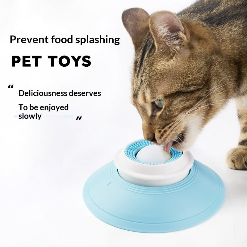 Cat playing with a blue and white pet toy on a white background