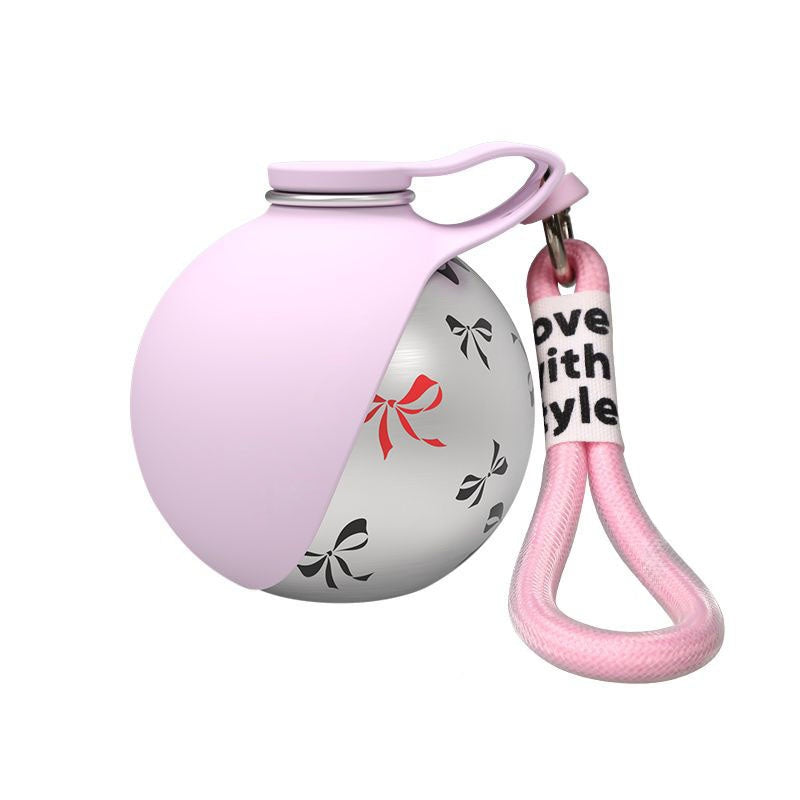 Pink ball-shaped keychain with a decorative strap on a white background