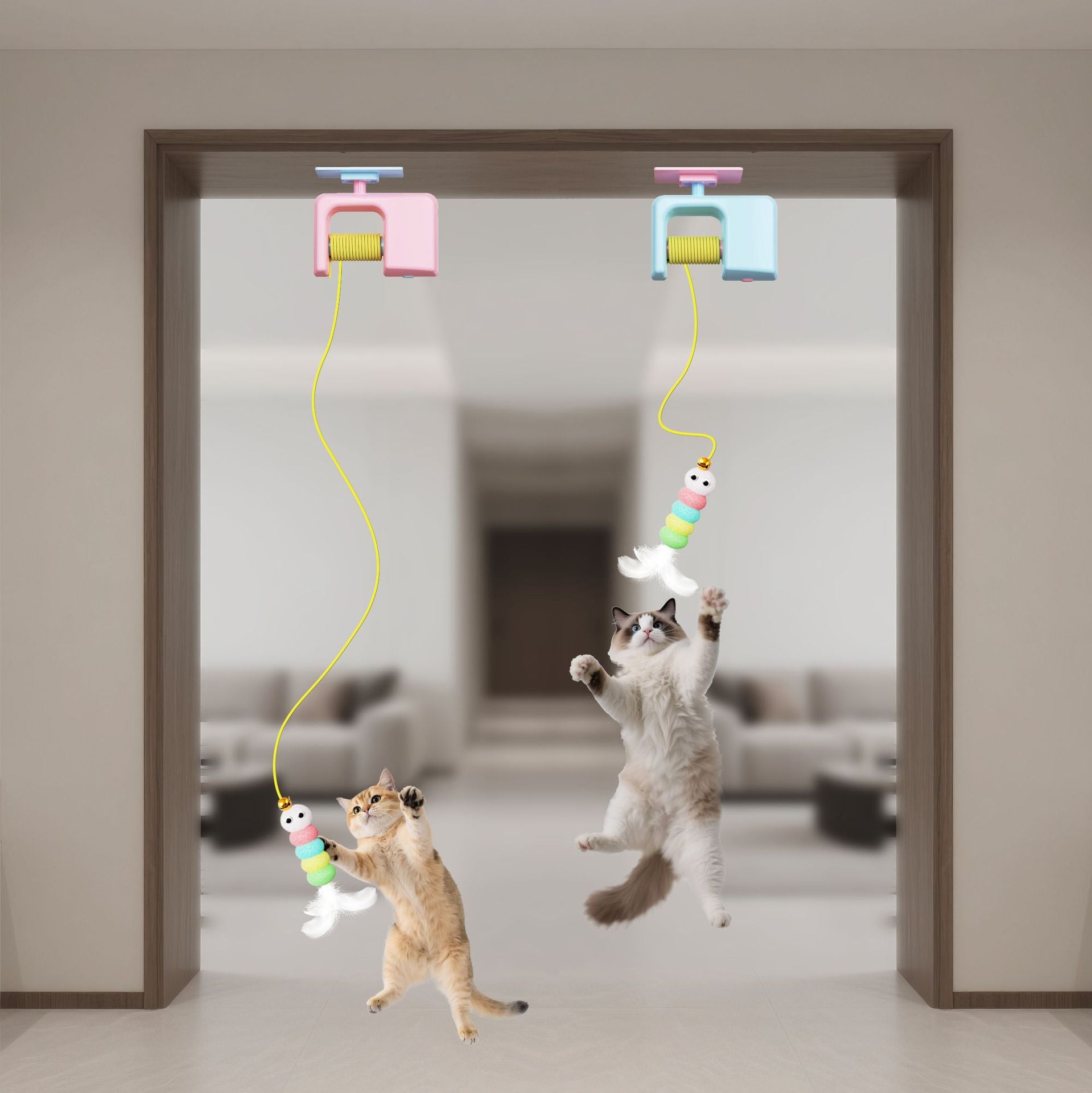 Two cats playing with a hanging toy in a room.